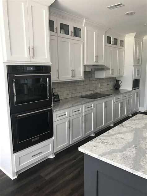 black handles on white kitchen cabinets with stainless steel appliances|shaker cabinets with black hardware.